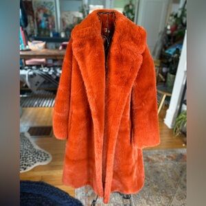 Rust colored faux fur midi length coat.